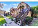 Attractive townhome facade with brick detail, stair access to upper units, and well-maintained landscaping at 366 Waterside Dr # 102, Altamonte Springs, FL 32701
