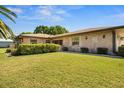 Charming single-story brick home with a well-manicured lawn and mature landscaping at 398 Troon Ct, Winter Haven, FL 33884