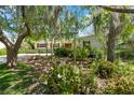 Landscaped front yard with flowering shrubs and mature trees giving a serene view of the home at 427 N Lakeview Ave, Winter Garden, FL 34787