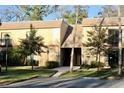 Close-up of a clean two-story condo building with mature trees and well-maintained landscaping at 429 Sheoah Blvd # 8, Winter Springs, FL 32708