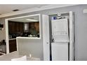 Functional laundry area with stacked washer and dryer adjacent to the charming kitchen area at 429 Sheoah Blvd # 8, Winter Springs, FL 32708