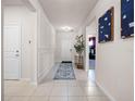 Bright foyer with white walls, tile flooring, decorative accents, and a welcoming ambiance at 4361 Lana Ave, Davenport, FL 33897
