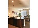 Open-concept kitchen with modern lighting and connection to the dining and living areas at 5105 Killarney Way, Kissimmee, FL 34746