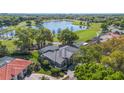 Aerial view of a single-story house next to a golf course and a lake at 703 Cricklewood Ter, Lake Mary, FL 32746