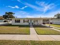 Inviting single-story home featuring a green lawn and a covered carport at 7108 Stockholm Way, Orlando, FL 32822