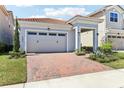 Charming single-Gathering home with a red brick driveway and well-manicured landscaping at 8006 Hoylake Dr, Orlando, FL 32832