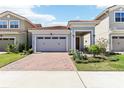 Charming single-Gathering home with a red brick driveway and well-manicured landscaping at 8006 Hoylake Dr, Orlando, FL 32832