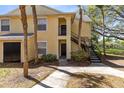 Attractive yellow condo with a convenient black door, front door access, and meticulously kept flowerbeds for curb appeal at 1017 S Hiawassee Rd # 3718, Orlando, FL 32835