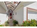 Inviting home entrance with a decorative door and well-maintained landscaping at 130 Hillside Dr, Davenport, FL 33897