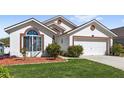 Beautiful single-story house with well-kept lawn and flowerbeds adding to its curb appeal at 130 Hillside Dr, Davenport, FL 33897