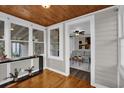 Open living room flowing from sunroom, featuring hardwood floors and neutral decor at 1407 Lantry Ct, Orlando, FL 32804