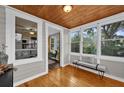 Inviting sunroom with hardwood floors, ample natural light, and comfortable bench seating at 1407 Lantry Ct, Orlando, FL 32804