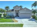 Inviting single-story home featuring a well-manicured lawn, garden, and a convenient two-car garage at 14228 Portrush Dr, Orlando, FL 32828