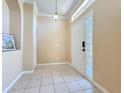 Bright foyer features tile flooring, front door with glass block window, and neutral walls at 14228 Portrush Dr, Orlando, FL 32828