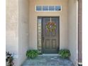 Charming front door entrance adorned with a wreath and stylish paving stones at 14228 Portrush Dr, Orlando, FL 32828