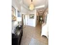 Bright hallway with tile flooring, chandelier and stylish decor at 14675 Scott Key Dr, Winter Garden, FL 34787