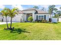 Well-manicured lawn and tasteful landscaping enhance the curb appeal of this bright home at 149 St Thomas Dr, Mulberry, FL 33860