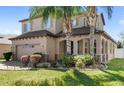 Attractive two-story home with mature landscaping, a two-car garage, and a covered front porch at 15604 Starlite St, Clermont, FL 34714