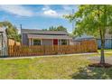 Charming single-story home with a red front door and a wooden picket fence at 1563 Immocalee St, Intercession City, FL 33848