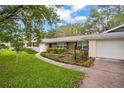 Lovely single-story home featuring a well-maintained lawn, walkway, and attractive landscaping at 1800 Johnson Dr, Clermont, FL 34711