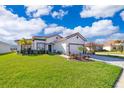 Beautiful home with lush green lawn, landscape beds, and brick-paved driveway at 2400 Symphony Cir, St Cloud, FL 34771