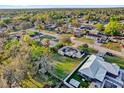 An aerial view of a residential neighborhood featuring a home with solar panels and a spacious backyard at 295 Garland St, Deltona, FL 32725