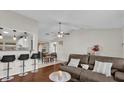 Comfortable living room with hardwood floors, breakfast bar, view of the dining room, and modern furnishings at 295 Garland St, Deltona, FL 32725