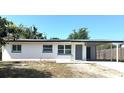 Charming single-story home featuring a carport and freshly painted exterior, creating a welcoming curb appeal at 300 S Aurora Dr, Apopka, FL 32703