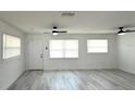 Bright and airy living room featuring modern flooring and natural light, offering a comfortable and inviting atmosphere at 300 S Aurora Dr, Apopka, FL 32703