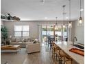 Bright and airy living room featuring an open-concept design, tile floors, and sliding doors to outdoor space at 31807 Broadwater Ave, Leesburg, FL 34748