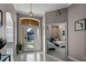 Bright foyer with stylish tile flooring, a decorative front door and an adjacent bedroom entrance at 334 Prestwick Dr, Davenport, FL 33897