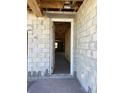 Unfinished interior view looking through a doorway, showcasing block walls and exposed ceiling beams at 5754 Cattle Ranch Dr, St Cloud, FL 34771