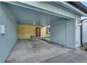 View of the carport featuring covered parking and a storage closet at 7468 Swallow Run # 38, Winter Park, FL 32792