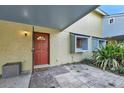 Welcoming front entrance with a red door and covered porch area at 7468 Swallow Run # 38, Winter Park, FL 32792