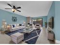 Bright living room featuring tile floors, a ceiling fan, and neutral colored furniture at 7468 Swallow Run # 38, Winter Park, FL 32792