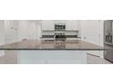 Kitchen island featuring stainless steel appliances and granite countertop at 8651 Sw 138Th St # 68, Ocala, FL 34473