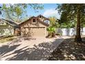 Home featuring a spacious two car garage, brick driveway, and well-maintained landscaping at 9939 Triple Crown Cir, Orlando, FL 32825