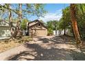 Shot of home with spacious two car garage, brick driveway, and mature landscaping at 9939 Triple Crown Cir, Orlando, FL 32825