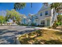 Street view of townhomes with beautiful landscaping, exterior paint colors, and ample parking at 1178 Vineland Pl, Lake Mary, FL 32746