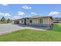 Beautifully landscaped home with stone accents, a three-car garage and a paver driveway at 12323 Sweet Hill Rd, Polk City, FL 33868