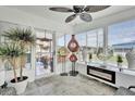 Relaxing sunroom featuring ceramic tile, fireplace, modern decorations, and plenty of sunlight at 1401 W Highway 50 # 45, Clermont, FL 34711