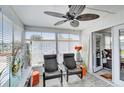 Cozy sunroom with two chairs, a ceiling fan, and ample natural light at 1401 W Highway 50 # 45, Clermont, FL 34711