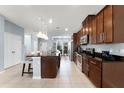 Updated kitchen featuring a large island, stainless appliances, and tile flooring at 15580 Blackbead St, Winter Garden, FL 34787