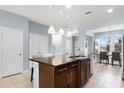 Spacious kitchen with island, granite countertops, and stainless steel appliances at 15580 Blackbead St, Winter Garden, FL 34787
