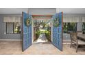 Bright foyer featuring tile flooring, a view of the front yard, and an open double-door entrance at 204 Smokerise Blvd, Longwood, FL 32779