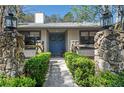 Inviting front entrance with stone accents, a blue double door, and manicured hedges at 204 Smokerise Blvd, Longwood, FL 32779