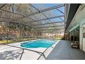 Refreshing screened-in pool with ample deck space for lounging and entertaining, nestled in the backyard at 204 Smokerise Blvd, Longwood, FL 32779