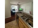 Open concept living room and kitchen featuring hardwood floors and access to the screened in porch at 2717 Maitland Crossing Way # 4-103, Orlando, FL 32810