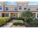 Lovely townhouse featuring manicured landscaping and a cozy front porch at 312 Carina Cir, Sanford, FL 32773