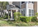 View of the home's attractive exterior with lush landscaping and a welcoming covered porch at 3398 Greenwich Village Blvd # 104, Orlando, FL 32835